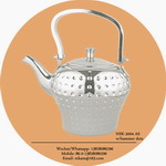 silver tea pot with hammer dots all